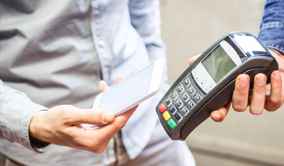 Man Paying With Mobile Phone