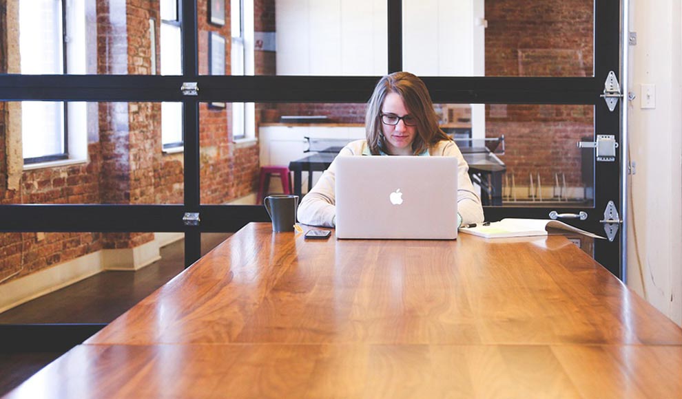 Woman Sitting in Front of a Laptop