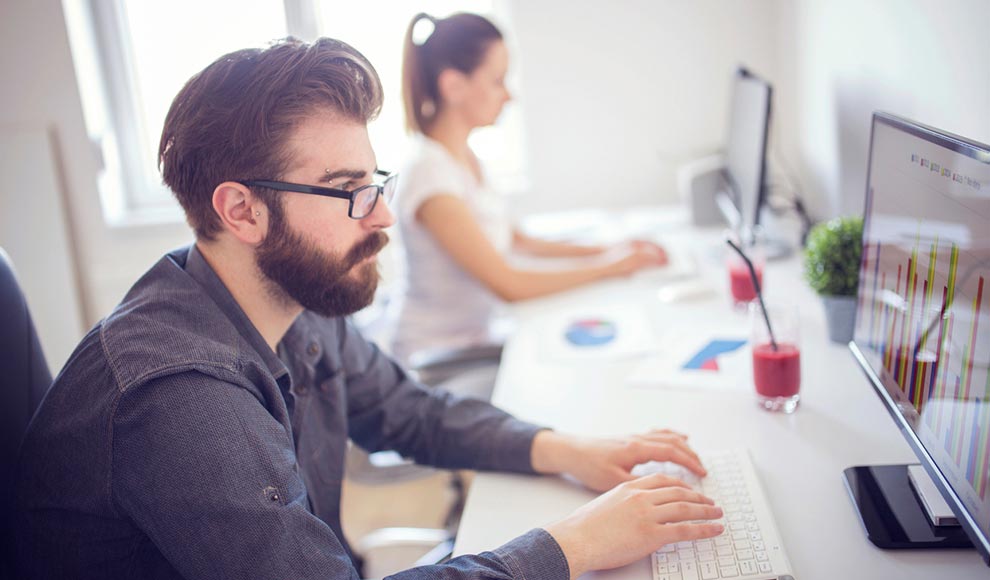 man working on desktop computer