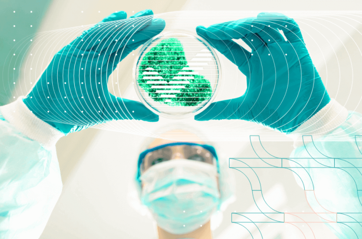 Scientist holding a Petri dish with microorganisms.