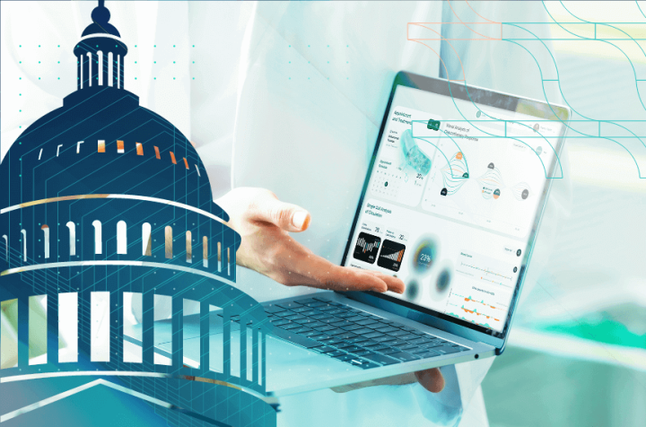 Professional showing data on a laptop, with the Capitol building in the foreground.