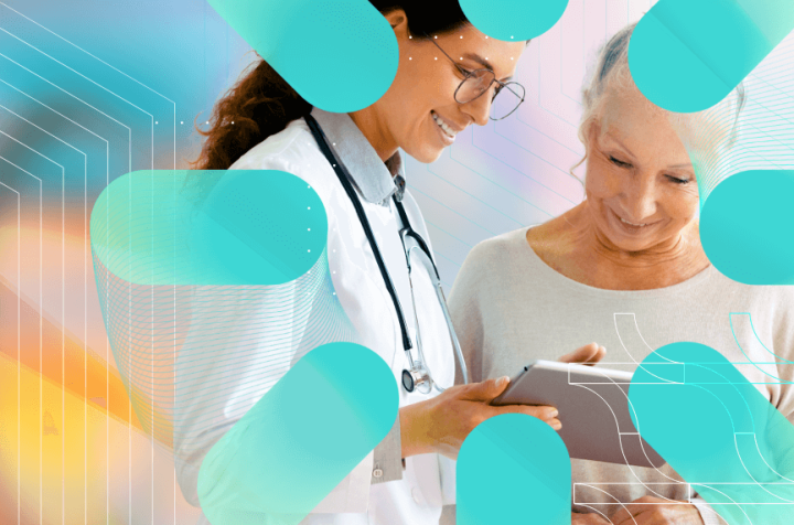 Smiling doctor and elderly woman reviewing information on a tablet.