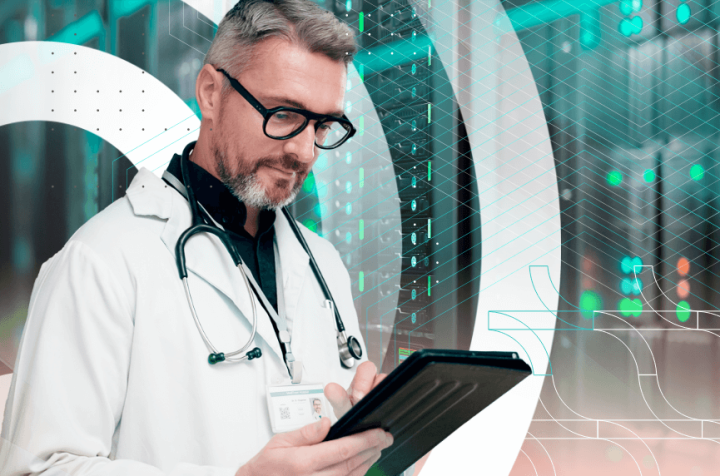 Elderly doctor with glasses and headset reviewing data on a tablet.