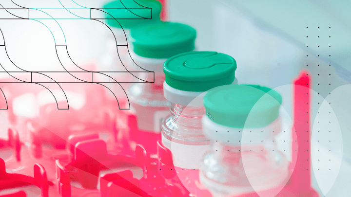 A row of medicine vials with green caps in a laboratory rack.