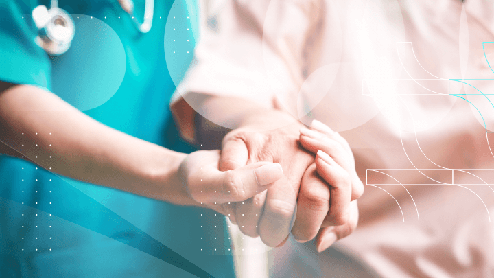 A nurse assisting a patient by holding their hand, symbolizing care and support.