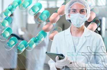 Female pharmaceutical manufacturing professional in lab coat, mask, and gloves holding a tablet device in a continuous manufacturing facility